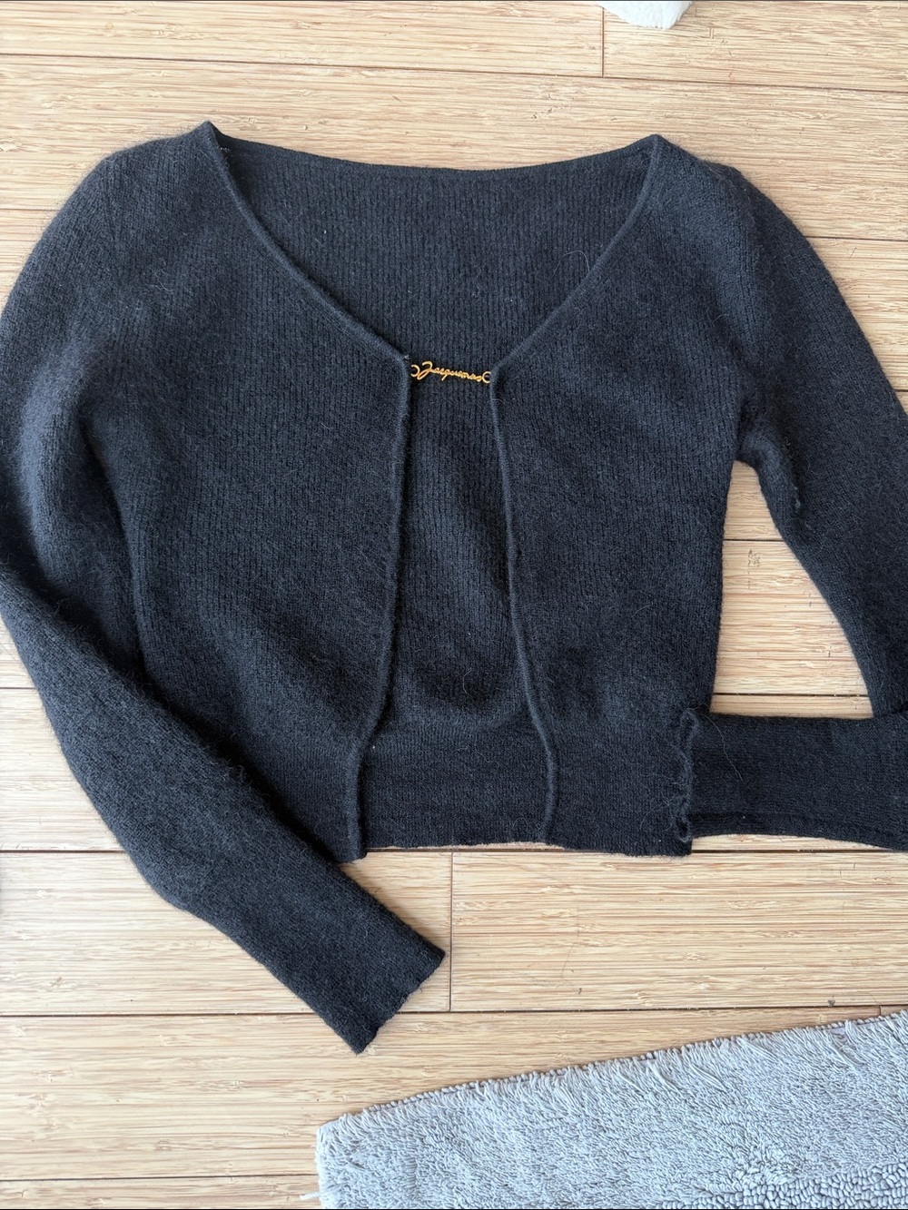 Jacquemus Black Cropped V-Neck Sweater with Gold Script Pin